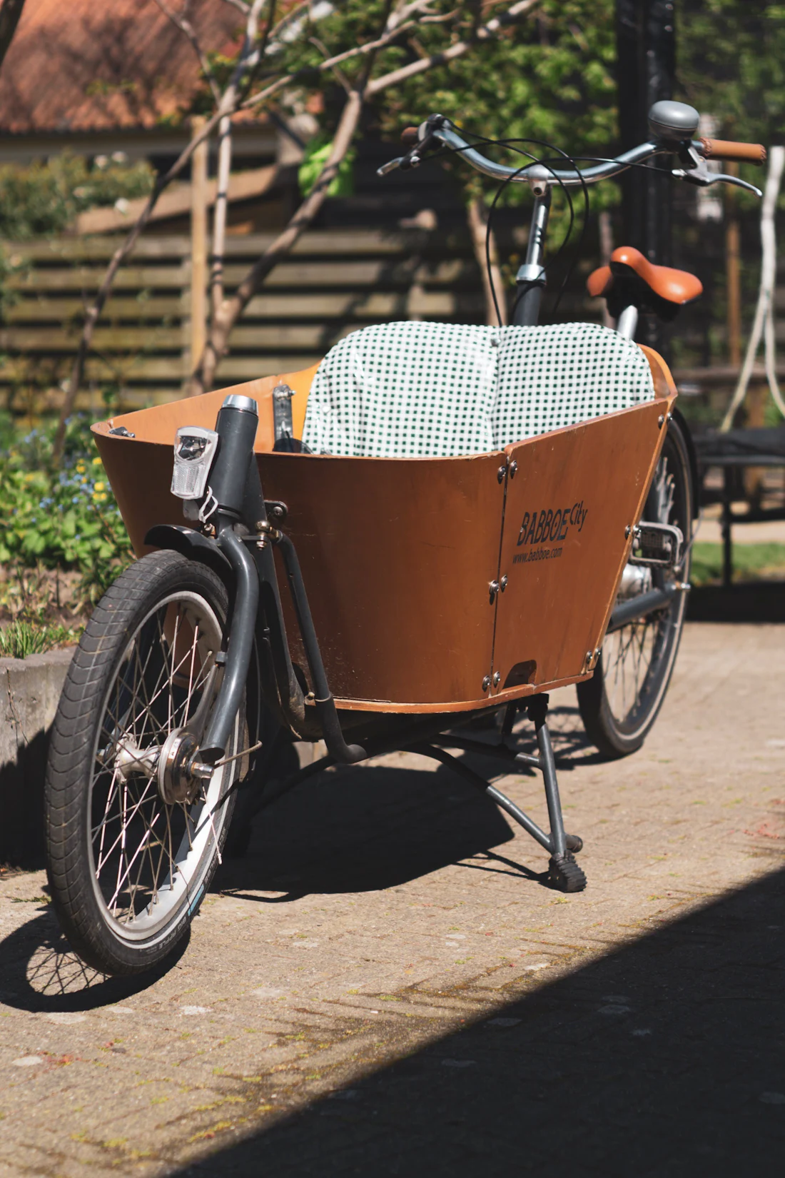 Vélo cargo en bois garé dans une cour